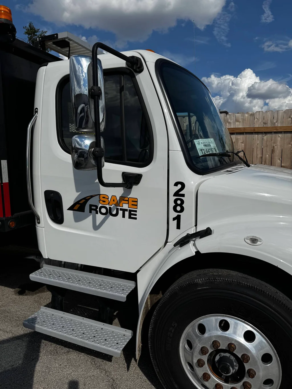 Close view of the cab of a white Safe Route branded truck.
