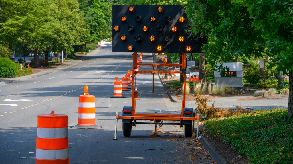 Arrow board trailer with traffic cones.